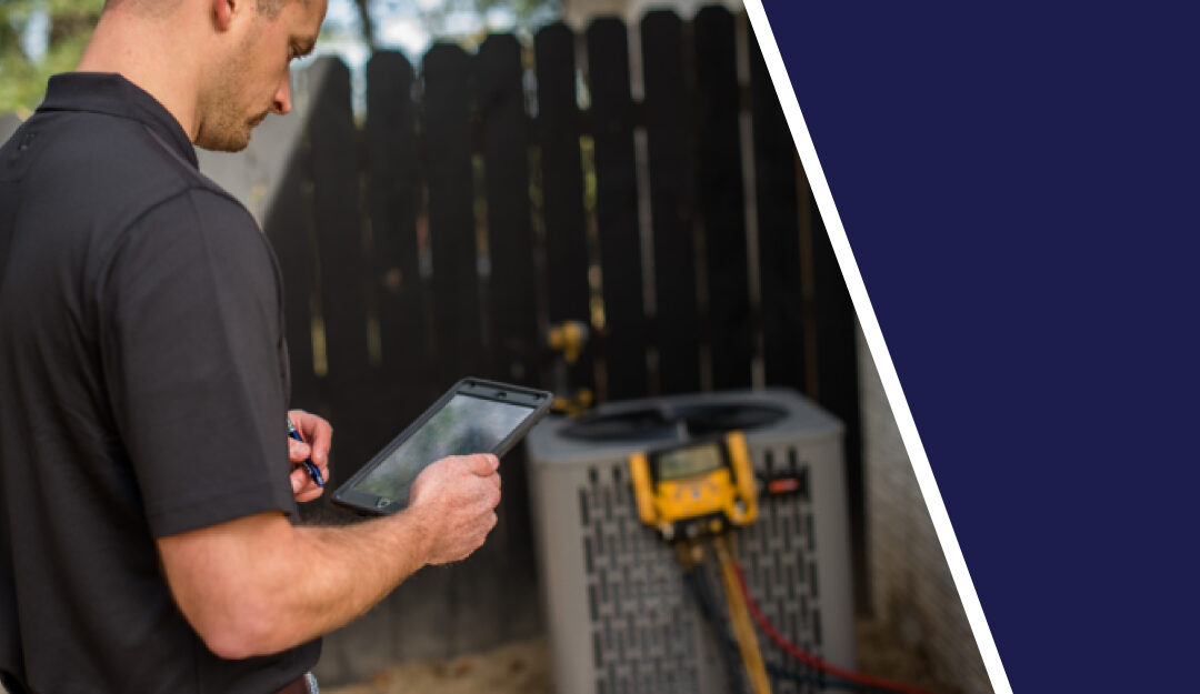 Man Using A Tablet To Examine The Health Of A Residential Air Conditioner