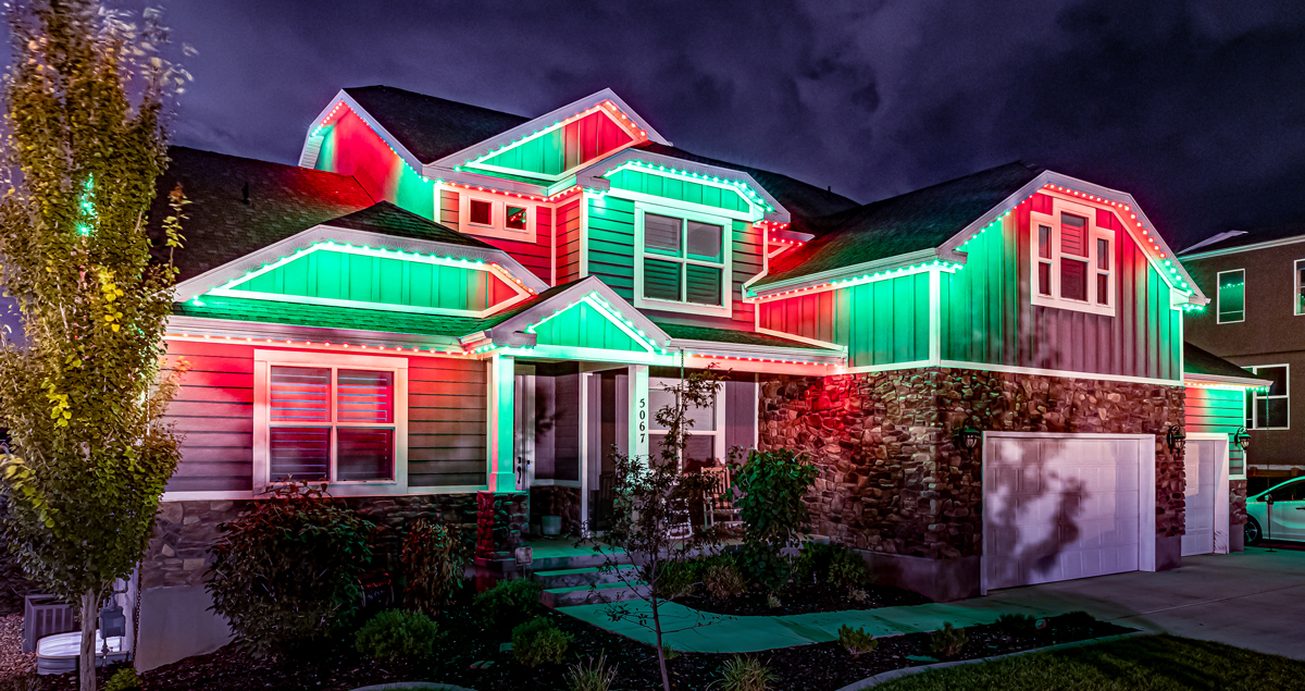 House With Christmas Trimlight Setup At Night